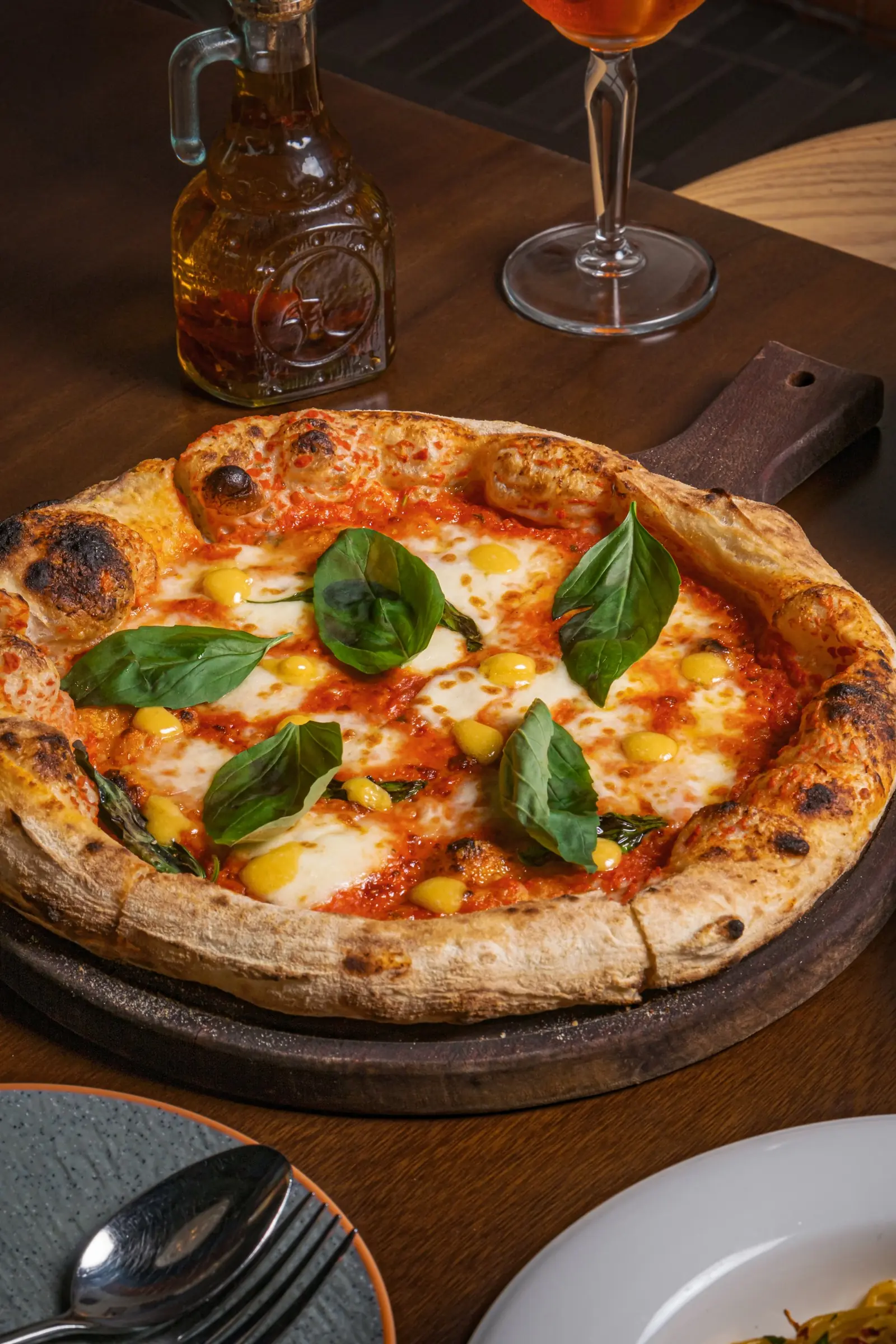 A Margherita pizza with basil at Casa Vostra
