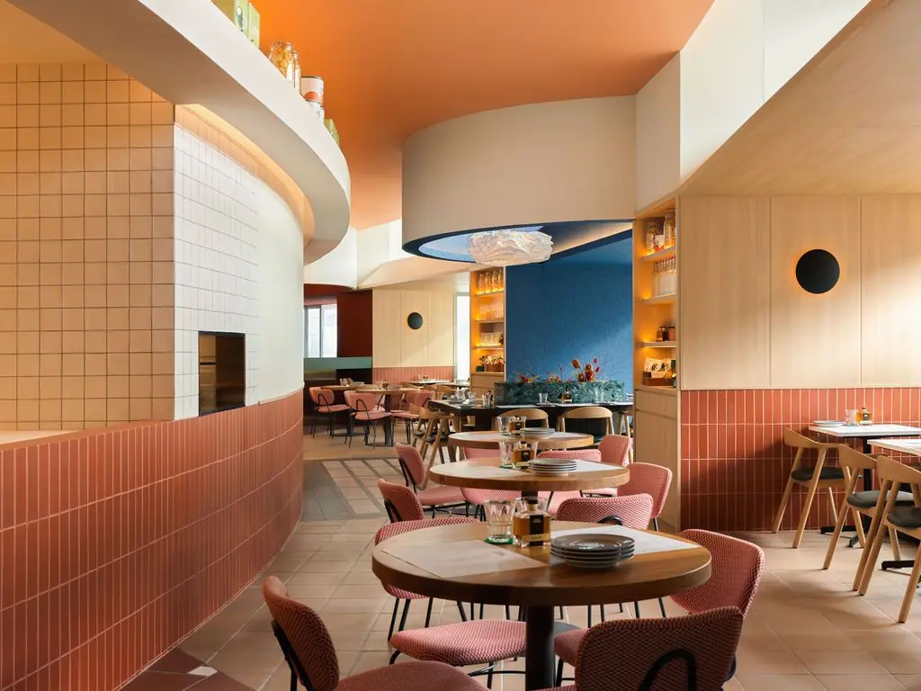 The dining room at Casa Vostra, with terracotta-tiled walls and coral chairs