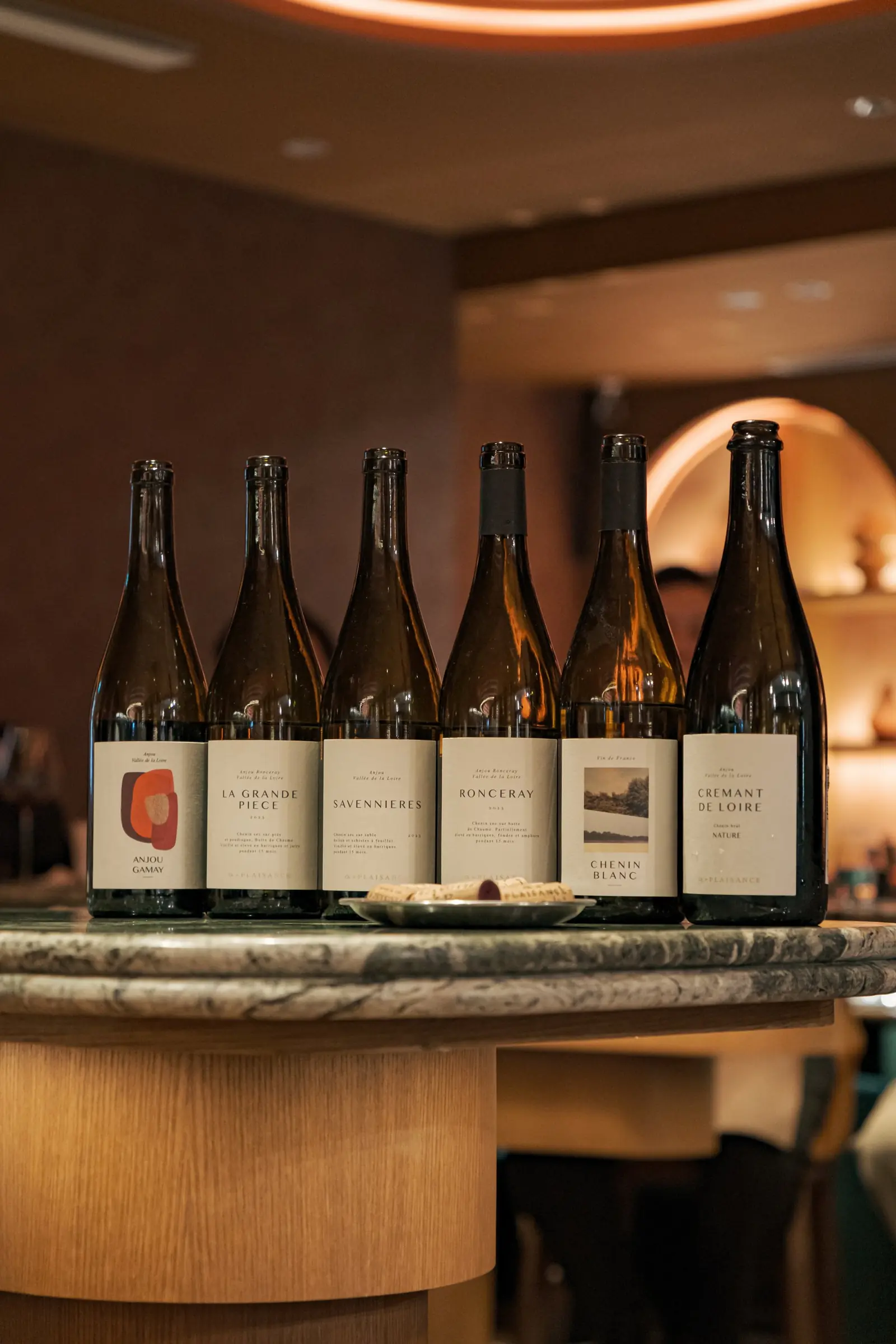A line of Ungrafted Vines bottles on a marble counter