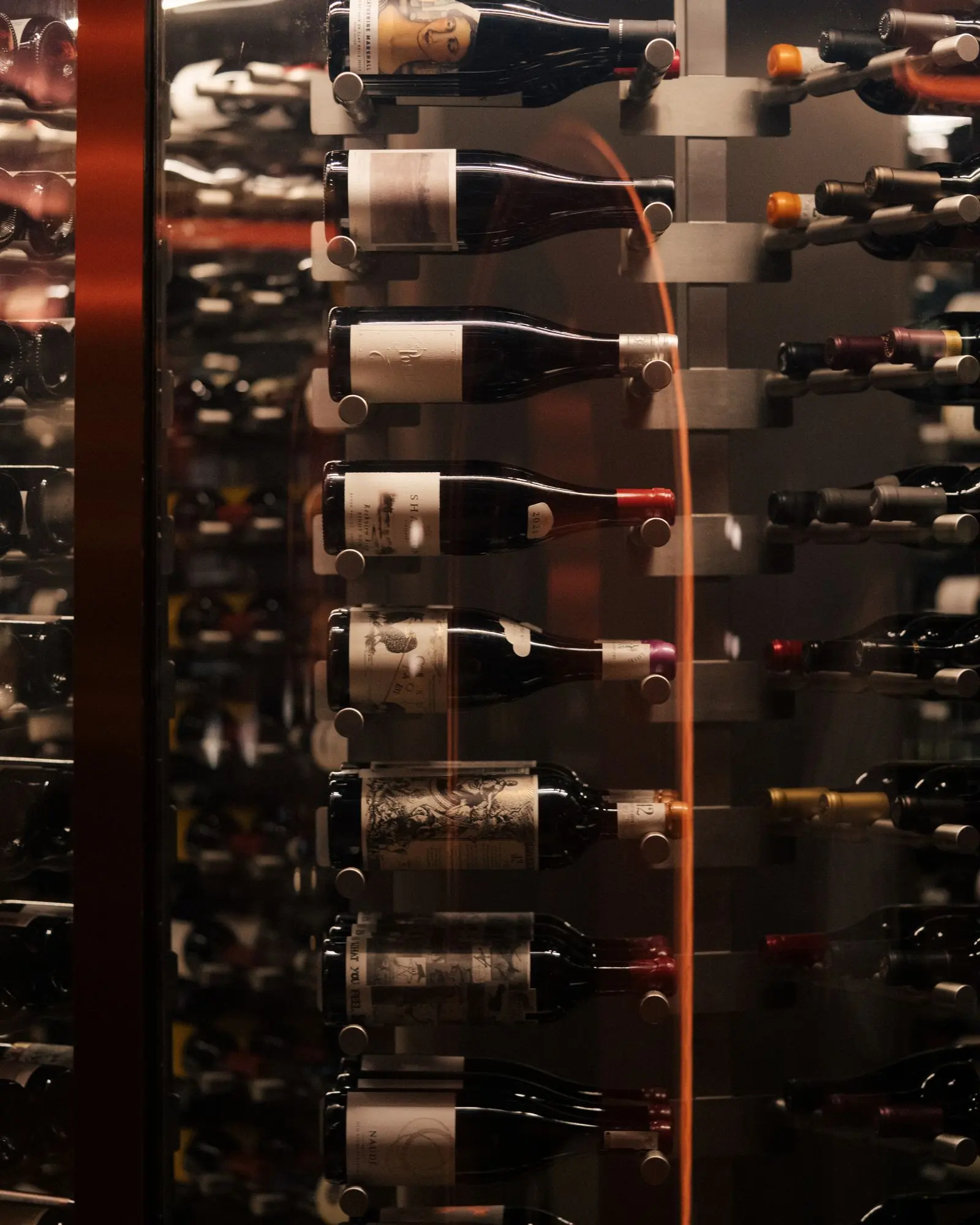 Wine bottles held on steel rods, from Ungrafted Vines