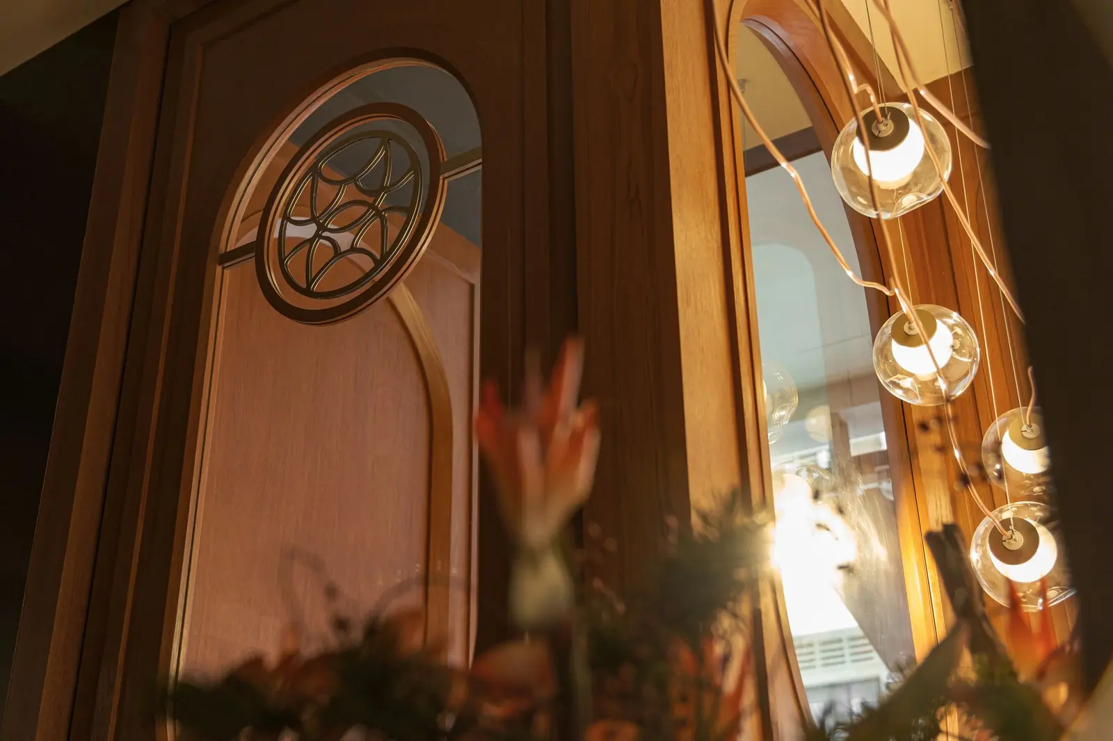 The arched wooden door and hanging lights at Willow