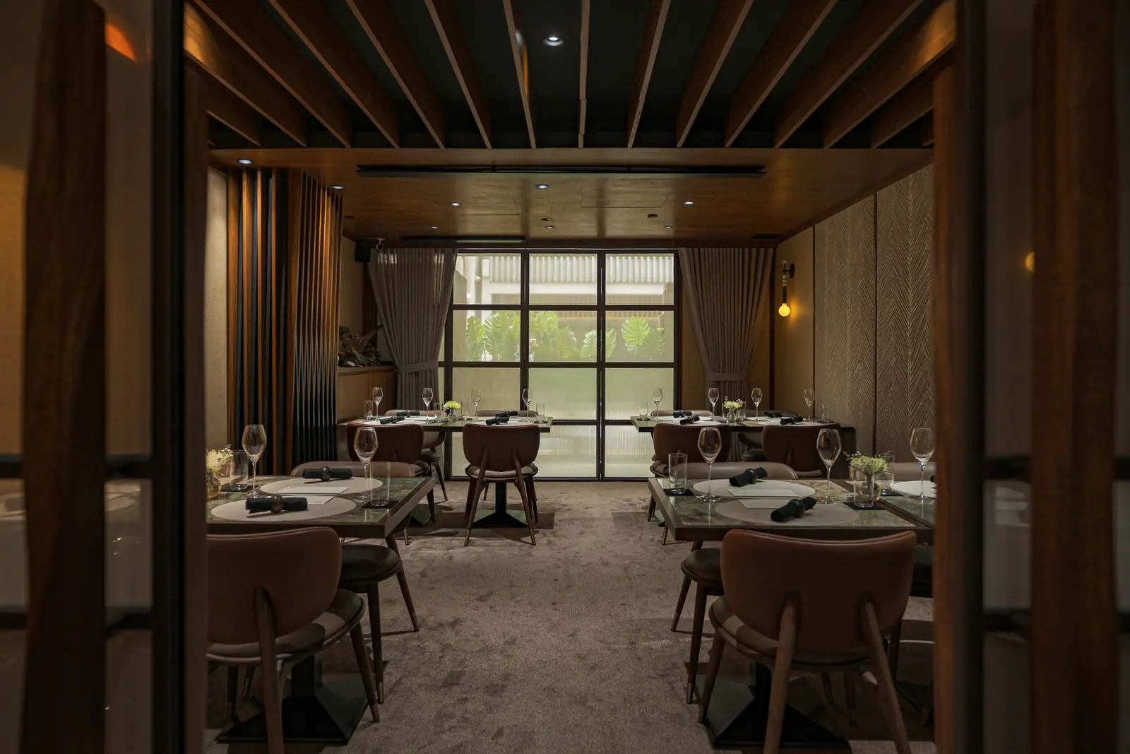 The private dining room at Willow, tables set under timber beams