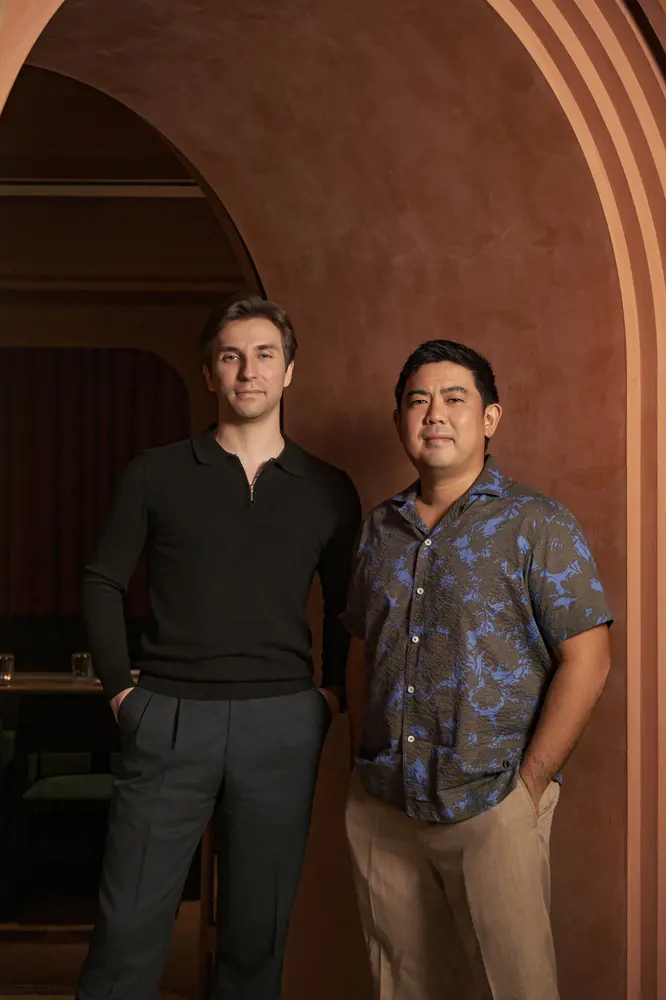 Philipp Hölke (left) and Lim Kian Chun (right) beneath a terracotta arch